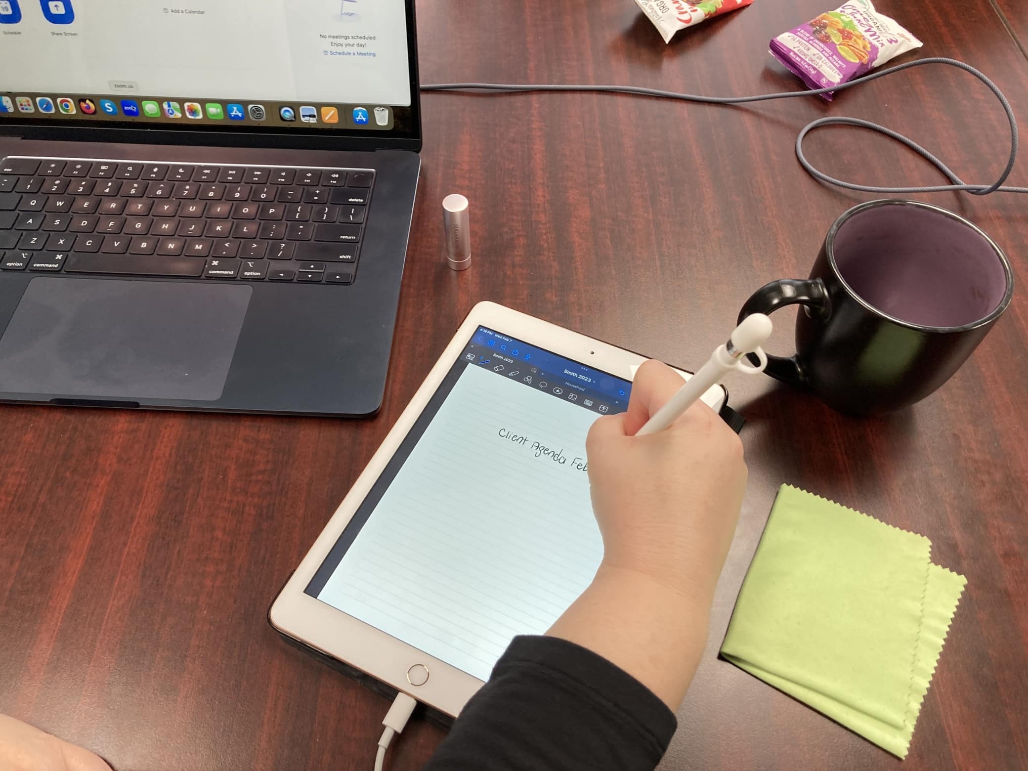 Photo of book author writing on a digital tablet sitting on a desk. Smith Publicity is one of the top book publishing publicity companies for independent authors